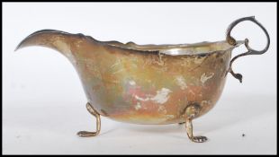 A silver hallmarked gravy boat by George Nathan & Ridley Hayes having a shaped rim and handle raised