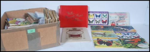 A quantity of cigarette cards and trade cards to include wildlife, birds, butterflies, coronation,