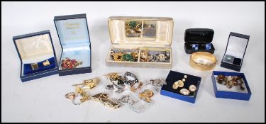 A collection of vintage costume jewellery to include a selection of gold plated cufflinks, a faux