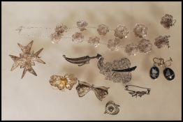 A collection of silver white metal filigree jewellery to include a dagger brooch, butterfly
