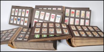 A collection of cigarette cards dating from the early 20th Century contained within four London
