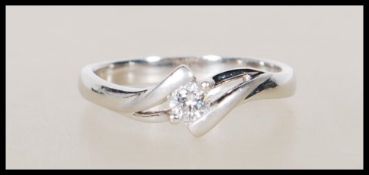 A stamped 18ct white gold solitaire diamond ring set to a decorative mount. Approx 15pts. Stamped
