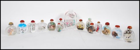 A collection of 14 assorted Chinese perfume bottles, each with a different design to each to include
