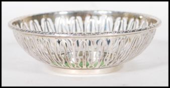 An English hallmarked trinket bowl having pierced decoration to the sides and garland decoration