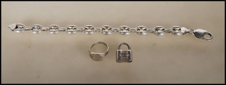 A contemporary Tiffany & Co silver ring (marked 925), a Tiffany & Co silver padlock charm and a
