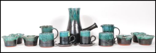 A vintage Woburn studio pottery coffee set having green mottled turquoise glaze rims to include