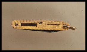 A 20th Century hallmarked 9ct gold pocket knife having engine turned decoration to body with