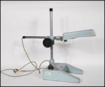 A retro mid 20th Century Stereoramic metal tabletop magnifier having adjustable stem with inbuilt
