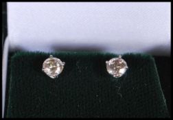 A pair of white gold and diamond single stone round cut stud earrings of approx 80 pts. Gross weight