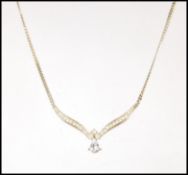 A vintage gold plated Christian Dior necklace having a V shaped collar terminating in a drop