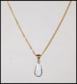 A stamped 375 9ct gold necklace chain having a drop shaped opal pendant on a gold bale. Weight 5.3g.