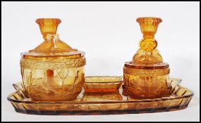 An early 20th Century Art Deco 1930's amber glass dressing table vanity set consisting of