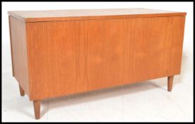 A retro 20th Century teak wood blanket box chest, hinged top raised on stub supports.  Measures: