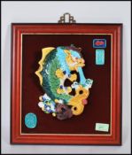 A 20th Century Chinese wall plaque having a raised ceramic hand painted green and yellow koi carp
