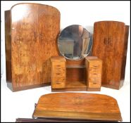 An early 20th Century Art Deco walnut bedroom suite comprising of double wardrobe, tall boy, bed