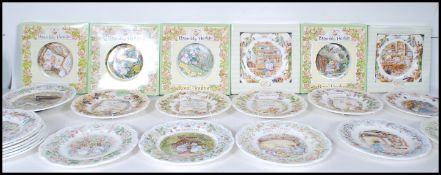 A group of 22 Royal Doulton Brambly Hedge ceramic collectors plates along with a wall clock to