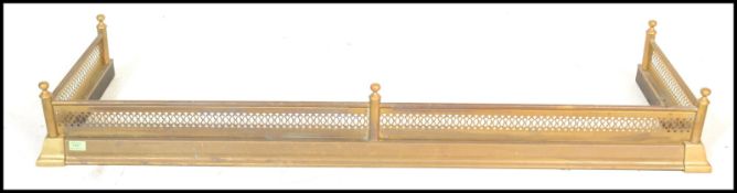 An early 20th Century extendable brass fire fender of simple form together with a selection of brass