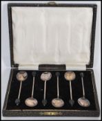 A boxed set of six 1930's art deco vintage solid silver hallmarked coffee bean spoons with coffee