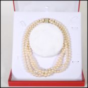 A 20th Century cultured pearl necklace having four strands of pearls united by a 9ct gold clasp