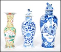 A group of three 19th Century Chinese vases / urns, one being famille jaune and verte having central