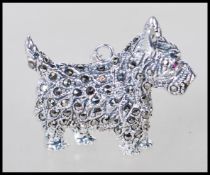 A sterling silver and marcasite pendant in the form of Scottish Terrier 'Scottie' dog having red