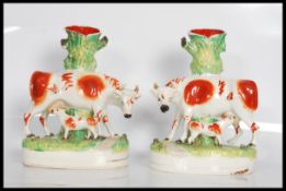 A pair of 19th Century Victorian Staffordshire flatback spill vases. Each having oval naturalistic