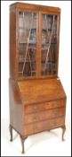 A 20th Century Georgian style Regency Revival mahogany bureau bookcase having twin astragal glazed