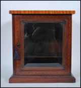 An early 20th Century 1930's mahogany smokers cabinet having satinwood inlaid flared top. The single