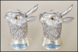 A pair of silver salt and pepper condiments in the form of hares having glass eyes. Stamped to bases
