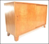 A mid 20th Century 1940's utility light oak sideboard of simple rectangular form having double