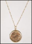 A stamped 9ct gold locket of round form engraved w