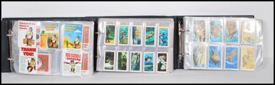 A collection of trade cards and giveaway cards over three albums to include Going Wild issued by