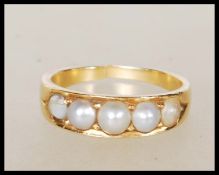 A vintage 18ct yellow gold ring set with five graduating pearls. Unmarked but tests as 18ct with