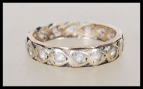 A 20th Century 9ct two tone eternity ring being set with white stones. Unmarked but tests as 9ct