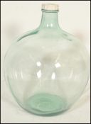 A retro 20th century large bulbous glass acid carboy bottle with thin waisted neck with original