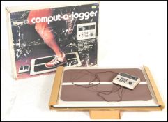 A retro 20th Century boxed rare Computer-A-Jogger computer plug in fitness running machine. Original