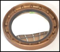 A mid 20th Century Regency style convex wall mirror. Of circular form  with ball finial