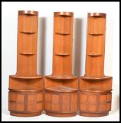 A group of three 20th Century teak wood corner display units by Nathan, the cabinets with twin