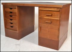 A mid 20th Century industrial Air Ministry teak wood twin pedestal desk, the right pedestal having