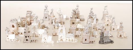 A group of thirty silver charm bracelet charms in the form of churches having articulated bases