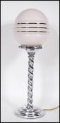 A early 20th Century 1930's Art Deco chrome table lamp having a spherical pink glass shade with