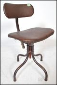 A retro vintage 20th Century industrial machinists swivel chair having a quadrapod base and