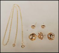 A collection of 9ct gold jewellery to include a pair of knot earrings, a pair of orb stud