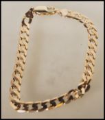 A hallmarked 9ct gold flat link bracelet with a lobster clasp. Assay marked for Birmingham. Weight