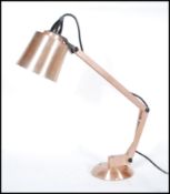 A retro 20th Century copper and plastic angle poise Mac Lamp, model number 8. Raised on a circular