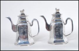 A pair of heavy cast matching silver plated Chinese teapots, the teapots with scroll spouts and