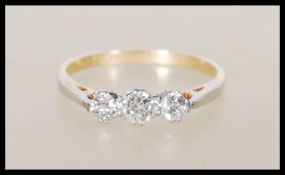 A 18ct yellow gold and platinum three stone diamond ring of approx 25pts. Marked for 18ct gold and