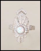 A stamped 925 silver and cz ladies Art Deco style dress ring having a central opal panel with cz's