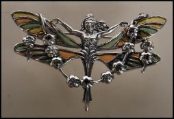 A stamped 925 silver and enamel plique a jour Art Nouveau style brooch in the form of fairy with her