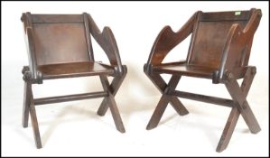 A pair of late 19th to early 20th Century oak ecclesiastical Glastonbury chairs in the Gothic